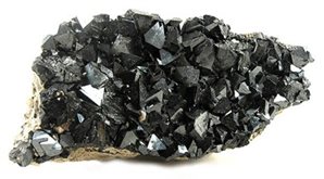 A black rock with many small crystals